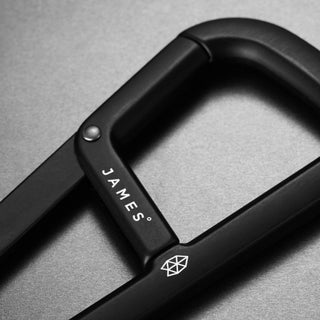 James The Hardin Carabiner in black anodized aluminum with sleek matte finish and dual compartment design