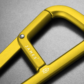 James The Hardin Carabiner in anodized yellow aluminum with dual compartment and spring latch design