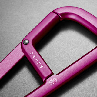 James The Hardin Carabiner in anodized purple aluminum with dual compartment and engraved logo detail
