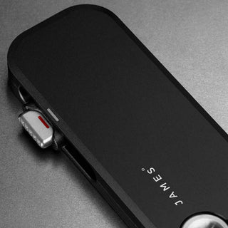 James The Palmer Knife with sleek black anodized aluminum handle and partially visible steel blade tab