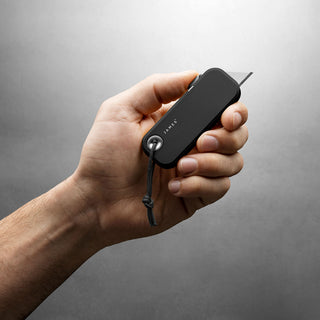 Hand holding James The Palmer Knife with black anodized aluminum handle and pull-out blade