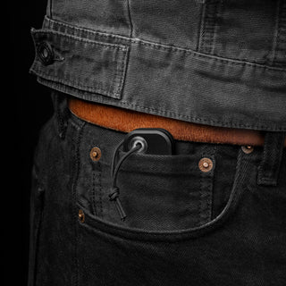 James The Palmer Knife in black anodized aluminum handle tucked in black denim pocket by The James Brand