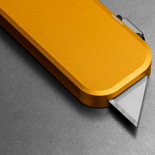 James The Palmer Knife with anodized gold aluminum handle and high carbon steel blade edge visible