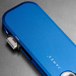 James The Palmer Knife in anodized blue aluminum with visible high carbon steel blade edge detail