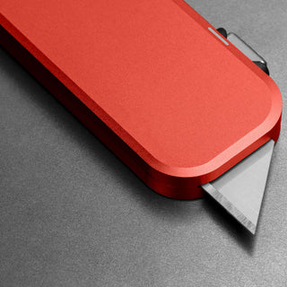 James The Palmer Knife showing red anodized aluminum handle with sharp high carbon steel blade edge