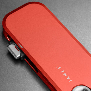 James The Palmer Knife in anodized red aluminum showcasing sleek, minimalist design and precision craftsmanship