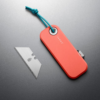 James The Palmer Knife with bright orange anodized aluminum handle and sharp stainless steel blade