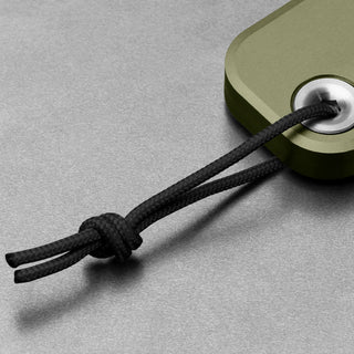Close-up of black lanyard cord attached to olive anodized aluminum handle of James The Palmer Knife