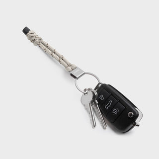 Orbitkey Urban Loop Keychain with beige paracord and attached keys and car remote on gray background