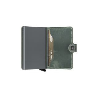 Secrid Miniwallet Vintage open showing green European cowhide and metal card protector with credit card inserted