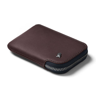 Bellroy Card Pocket in dark brown leather with zipper closure and embossed logo detail on surface