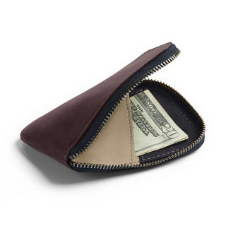 Bellroy Card Pocket in brown leather with zipper open showing folded US dollar bill inside