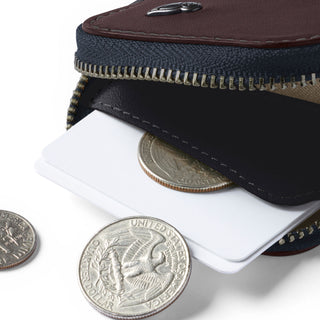 Bellroy Card Pocket leather wallet partially unzipped showing card and coins inside pocket