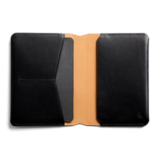 Bellroy Passport Cover in black leather open view showing smooth tan interior lining and card slot