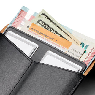 Bellroy Passport Cover in black leather holding cards, cash, and a passenger card in multiple slots
