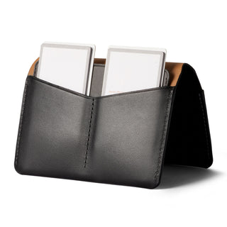 Bellroy Passport Cover in black leather with two card slots and smooth texture standing open