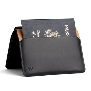 Bellroy Passport Cover in black leather partially holding a United States passport upright