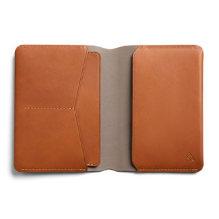 Bellroy Passport Cover open flat showing smooth tan leather with card slots and soft lining interior