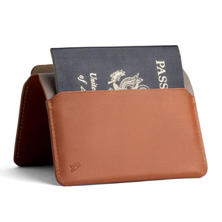 Bellroy Passport Cover in tan leather holding a partially visible United States passport
