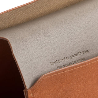 Bellroy Passport Cover showing tan leather interior with embossed motivational message inside flap