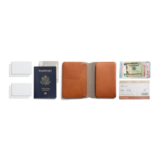 Bellroy Passport Cover open with brown leather and organized travel essentials including passport and currency