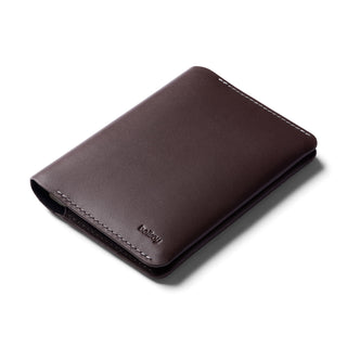 Bellroy Passport Cover in rich dark brown leather with contrasting white stitching and embossed logo
