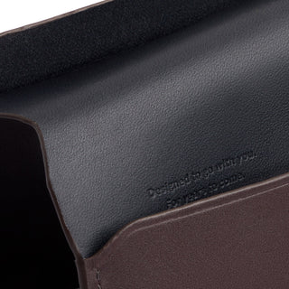 Bellroy Passport Cover showing smooth black interior leather and rich brown exterior texture close-up