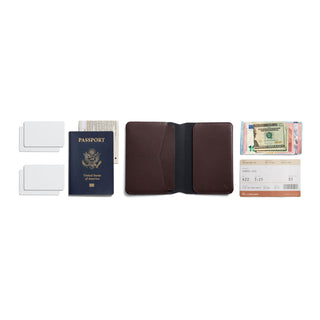 Bellroy Passport Cover open flat with passport, cards, cash, and travel essentials displayed on white background