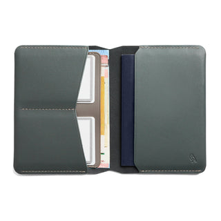 Bellroy Passport Cover in dark green leather open to reveal card and passport slots with neat stitching detail