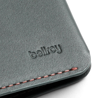 Bellroy Passport Cover in gray leather with embossed logo and contrasting detailed stitching close-up
