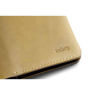 Bellroy Passport Cover in tan leather with embossed logo and detailed stitching on the corner edge