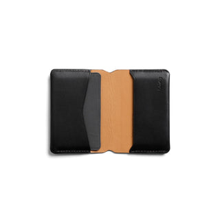 Bellroy Under Cover card holder with smooth black leather exterior and tan leather interior lining open flat