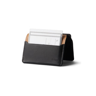 Bellroy Under Cover black leather card holder displaying inserted cards with a tan interior lining