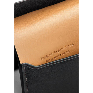 Bellroy Under Cover wallet showing tan leather interior with embossed motivational text and black exterior trim