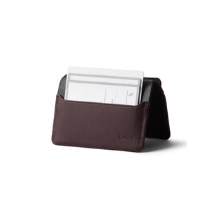 Bellroy Under Cover brown leather card sleeve standing with card partially inserted visible stitching