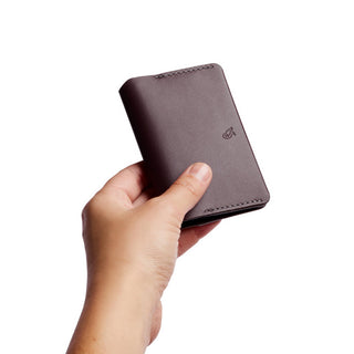 Bellroy Under Cover compact brown leather wallet held in hand showing smooth texture and minimal logo