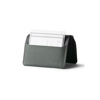 Bellroy Under Cover slim leather cardholder in green holding white cards against white background