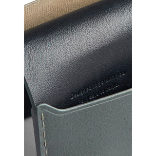 Bellroy Under Cover card sleeve showing black and gray leather textures with embossed message detail