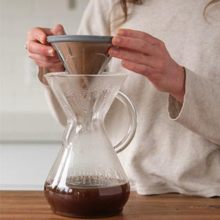 Able Kone Filter for Chemex 6, 8, 10 Cup Coffee Maker held above glass Chemex brewing vessel with coffee inside