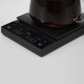 HARIO Polaris Coffee Scale in black ABS resin with digital timer and weight display beneath glass platform