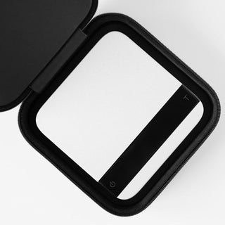 ACAIA Lunar Carrying Case with black zipper and cushioned shock-absorbent interior holding a compact scale