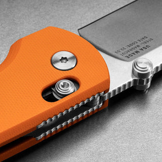 James The Kline Knife featuring bright orange Micarta handle and detailed stainless steel blade lock mechanism
