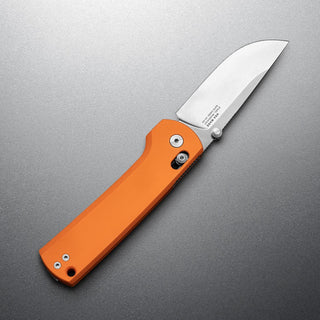James The Kline Knife with bright orange Micarta handle and polished drop point blade on gray background
