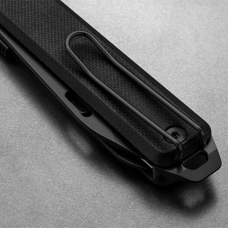 Close-up of the James The Ellis Scissors Knife clip and textured black Micarta handle by The James Brand