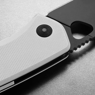 James The Folsom Knife with textured white G10 handle and black serrated VG-10 blade close-up detail