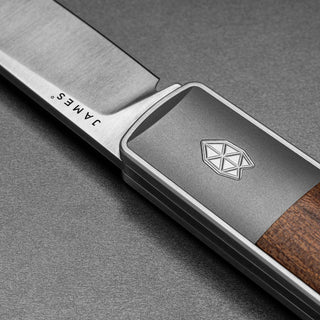 Close-up of James The Wayland Knife handle with rosewood and engraved metal accent by The James Brand
