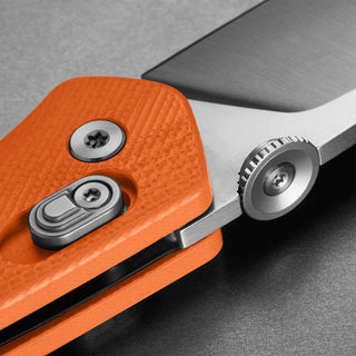 James The Carter Knife close-up on textured orange Micarta handle and VG-10 steel blade detail by The James Brand