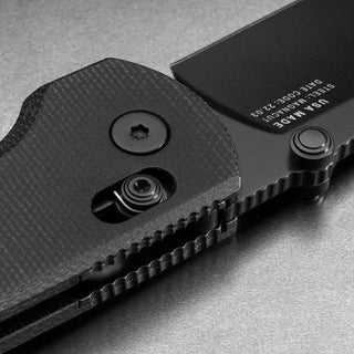 James The Kline Knife close-up showing black Micarta handle texture and CPM Magnacut steel blade details