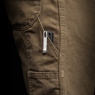 James The Kline Knife with black Micarta handle clipped on brown cargo pants pocket close-up