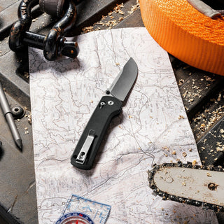 James The Kline Knife with matte steel blade and black Micarta handle resting on a topographic map